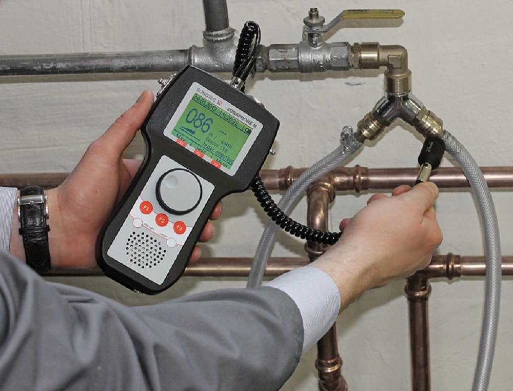Plumber testing pipes with electronic leak detection equipment in West Linn