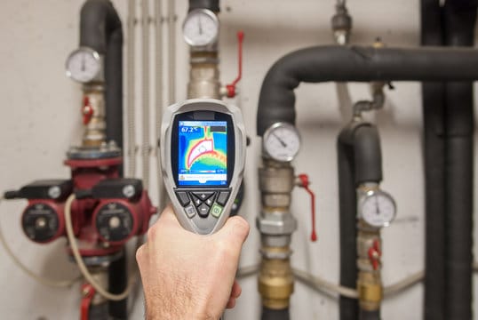 Plumber using a thermal imaging camera to inspect pipes in West Linn